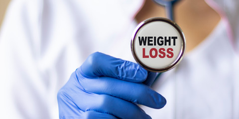 Weight Loss card in hands of Medical Doctor