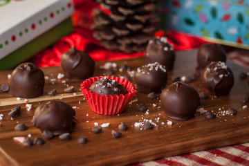 chocolate truffles on a wooden table with pinecone