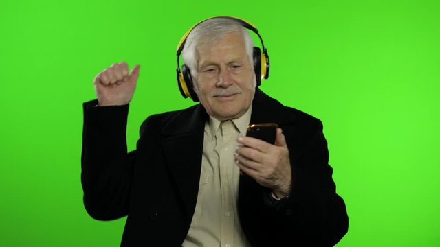 Elderly caucasian grandfather man dance, celebrate, listen music. Chroma key