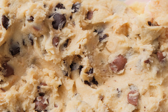 macro shot of chocolate chip cookie dough. the process of cooking a family recipe. dark and milk chocolate ingredients. gluten free flour. food background texture