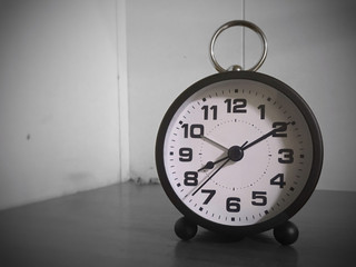 A waker clock on the table in black and white view