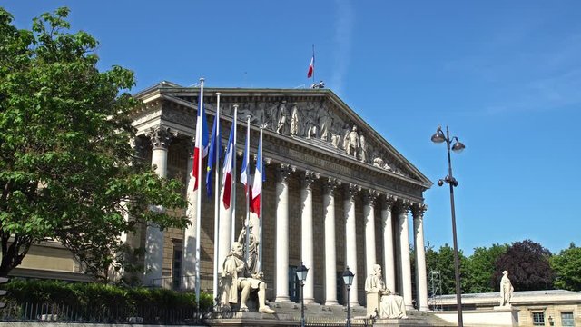 Paris, France: French and European Union flags in the wind in front of National Assembly