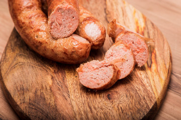 salmon sausage, On a  wooden textured background wooden cutting Board with on which salmon sausage grilled. Top view macro