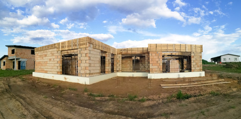 Fototapeta na wymiar Panorama of house under construction in construction site