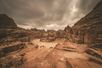 The ancient Nabatean  city of  Petra in Jordan, street of facades among sandy mountains in the desert in stormy and gloomy weather