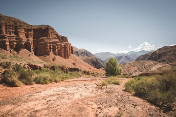  fantastic clay red castles in the sandy desert of the  canyon Konorchek, in Kyrgyzstan