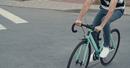 Fototapeta na wymiar Young hipster man riding bike