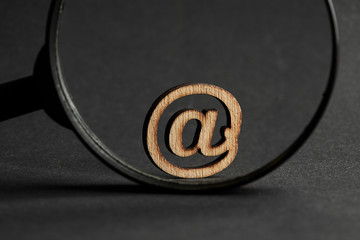 business communication mail technology concept. email symbol with magnification glass over dark moody background