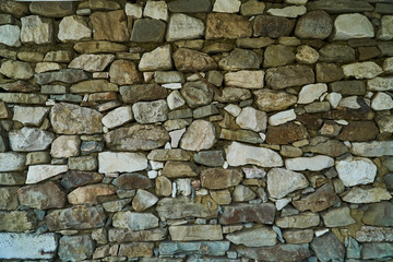 Fototapeta premium The texture of the stones. The stone splits. Rocks in the section. Tiles and mountains. The Wallpaper is grey.
