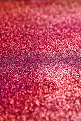 Red  sparkling  background. Abstract twinkled red glittering texture with bokeh, defocused lights for Christmas holiday, banner, wedding invitation and greeting cards.