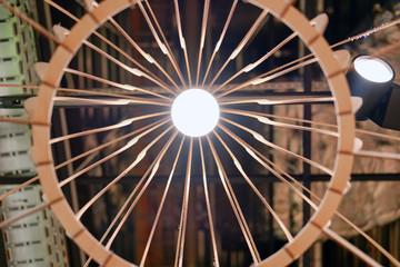 Bottom view of a wooden homemade lamp, background