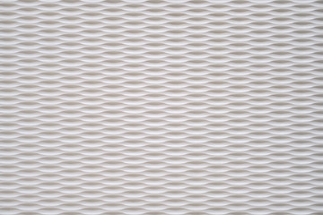 Wall texture with white rounded recesses in even rows. Futuristic background