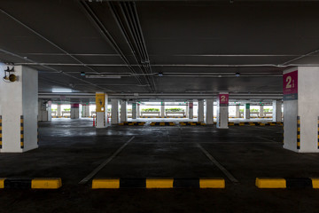 Empty space car park interior at afternoon.Indoor parking lot.interior of parking garage with car and vacant parking lot in parking building.some carpark empty in Condominium or department store.