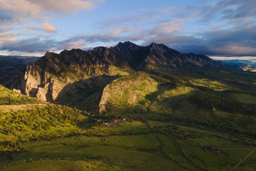 morning sun on mountain valley and spring fields with sunrise sky background