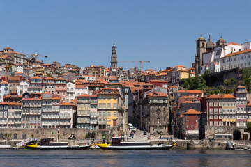 Obraz premium Colorful houses of Porto Ribeira, traditional facades, old multi-colored houses with red roof tiles on the embankment in the city of Porto, Portugal. Unesco World Heritage.