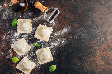 Fototapeta na wymiar Homemade fresh Italian ravioli pasta with mushrooms on dark background.