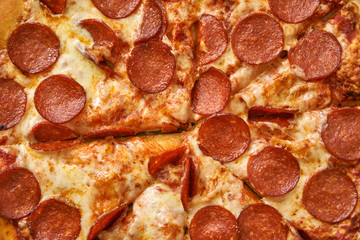 Pizza assorted pepperoni in a box and on a white plate. Fresh hot pizza with cheese and seafood.