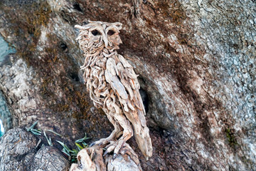 an owl figure made of pieces of wood