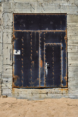 An abandoned stone house on a Sunny day. An old building, an empty city on a mountain, and a blue sky. Broken stone walls.