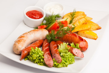 beautiful photo close-up menu of potatoes, sausage salad on a plate on a white background