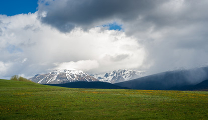 Fototapeta premium Rain Clouds over Canadian Mountains and a Speck of Blue Sky