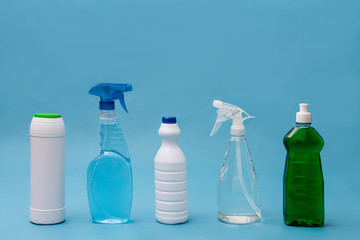 Household cleaning products on blue background.
