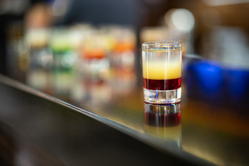beautiful photo of an alcoholic shot prepared by a bartender at the bar