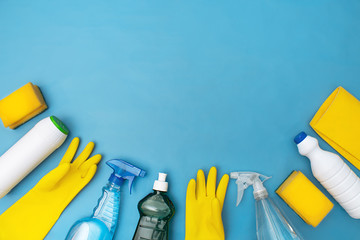 household cleaning products on blue background on flat lay