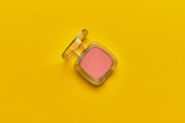 Women cosmetic blush on a yellow background