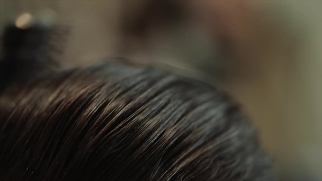 Men's haircut close-up shooting. Close-up video of haircut and hair styling.