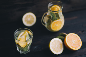 Fototapeta na wymiar Summer refreshing citrus and kiwi lemonade. Homemade infused water with lemon and cucumber. Tasty cold vitamin beverage