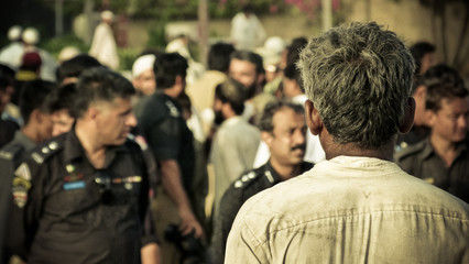 Man standing with a group of officer around