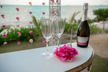 White table for a wedding ceremony with decorations on the seashore.