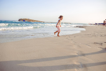 Fototapeta na wymiar happy little girl have fun and joy time at beautiful beach