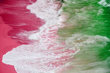 Raging ocean, azure coast with a golden sandy beach. Top view, drone view Benagil Beach in Portugal.