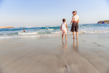 happy  little girl have fun and joy time at beautiful beach