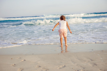 Fototapeta na wymiar happy little girl have fun and joy time at beautiful beach