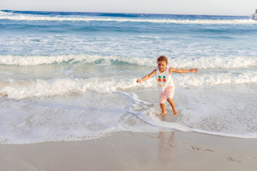 happy  little girl have fun and joy time at beautiful beach