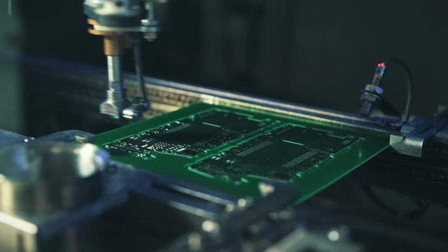 Robotic chip manufacturing. Automatic electronic soldering of microchips. Close-up.