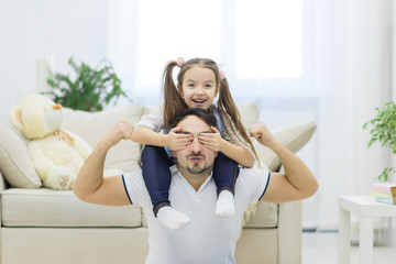 Father and daughter playing at the day time.