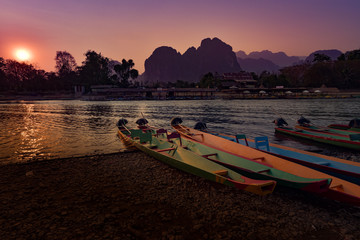 Fototapeta premium Colorful Wooden Boats Nam Song River at Sunset Vang Vieng Laos