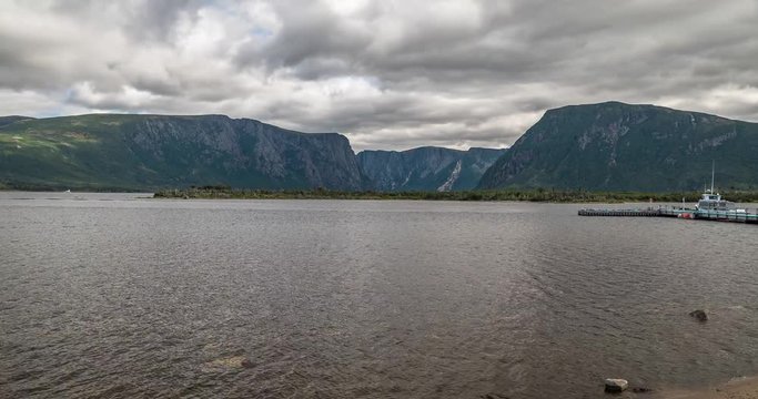 Gros Morne National Park, Newfoundland, Canada. Time lapse of western brook pond mid day with the tour boats leaving the dock. Includes 2 versions - Static + digital tilt up.