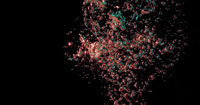 orange bubbles dispersing against a black underwater background.