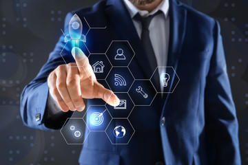 Startup concept. Businessman on dark background, closeup