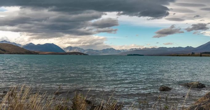 Lake Tekapo, New Zealand. Time lapse over the lake facing the mountains on a cloudy evening. Includes 3 versions - stationary, and digital pan/digital zoom out using full resolution of the image.