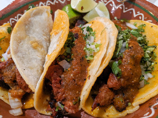 tacos with salsa on mexican bowl