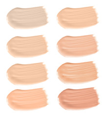 Set of different foundation shades on white background, top view