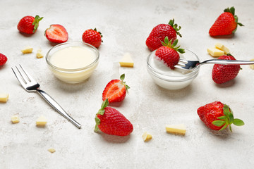 Tasty strawberry with melted chocolate on grey background