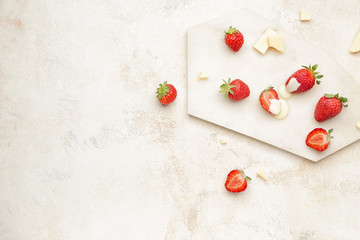Naklejka na ściany i meble Board with tasty strawberry and melted chocolate on light background