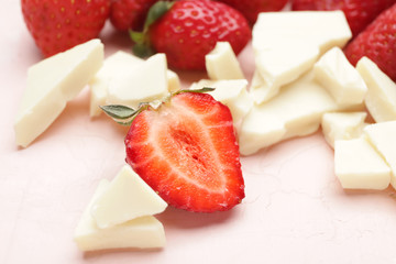 Tasty strawberry and white chocolate on color background